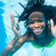 Black girl diving in swimming pool